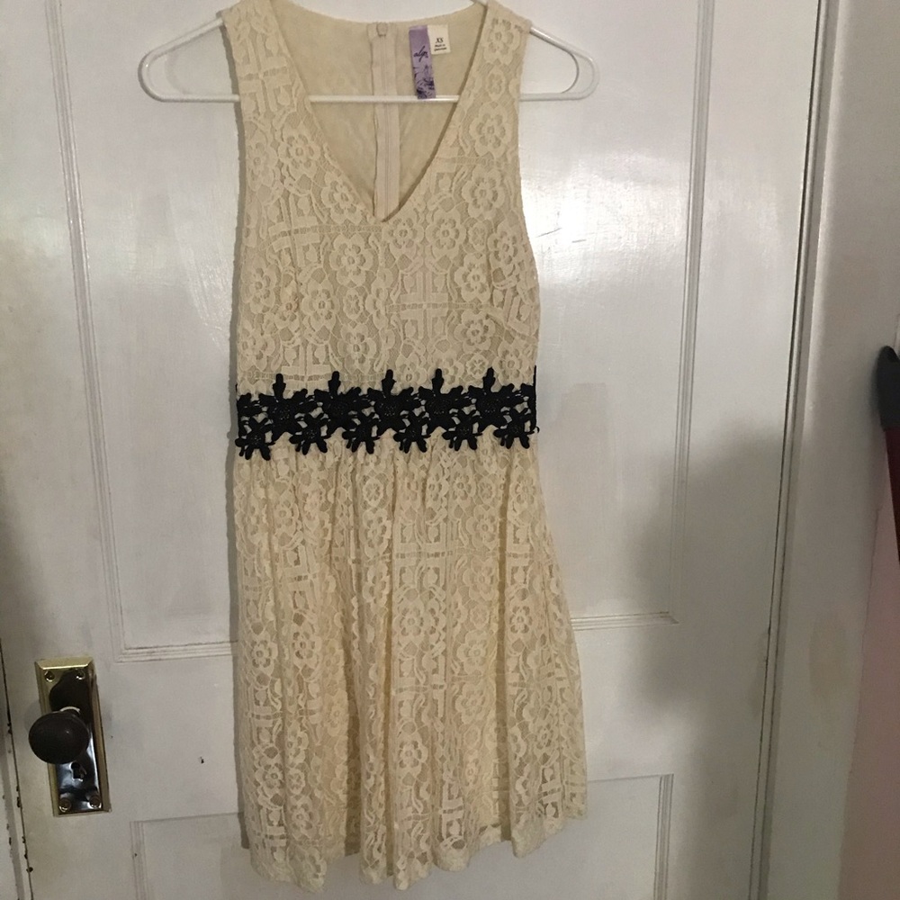 Cream lace dress with black detailing “belt”